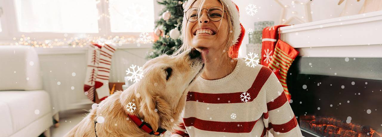 Lady and dog next to christmas tree