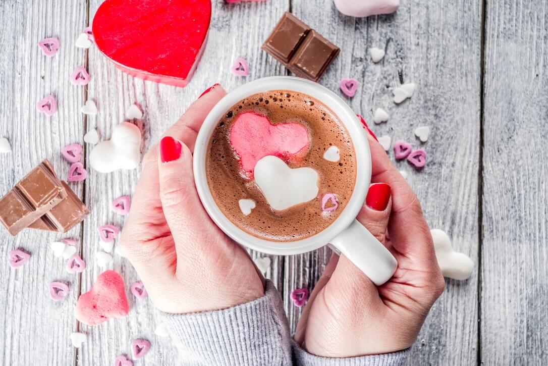 Valentines Day gifts and coffee with heart shapes in the foam